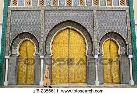 Stock Image - Fez Morocco Royal Palace famous Golden Doors arches Der el Makhzen with arab man walking.. Fotosearch