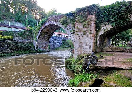 Stock Image - Fish Men' sculpture beside Puente Mayor bridge over Miera river, Lierganes, Comarca de Trasmiera, Cantabria, Spain. Fotosearch