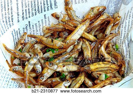 Stock Photo - France. Aquitaine. Gironde. Food. on the Gironde estuary at Macau, some Eperlands frits en persillade". (Smelt fishes from the "carrelet" fishery on the river side). ". Fotosearch