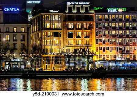 Stock Image - Geneva at night, buildings along Rhone river, Switzerland.. Fotosearch