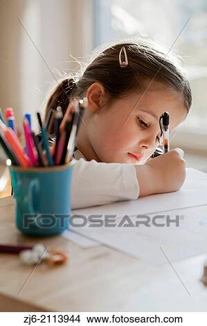 Girl drawing on paper. View Large Photo Image Picture - Girl drawing on paper.. Fotosearch
