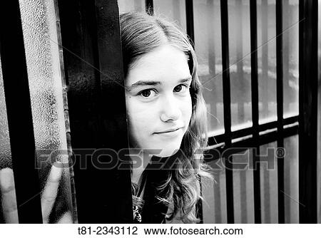 Stock Image - girl looking at the door of the school. Peniscola, Castellon.. Fotosearch