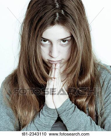 Stock Image - girl watching with hands clasped, Valencia study. Fotosearch