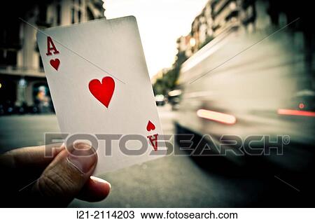 Hand holding an ace of hearts in a street while passing moving vehicles. Barcelona, Catalonia, Spain. View Large Photo Image Stock Image - Hand holding an ace of hearts in a street while passing moving vehicles. Barcelona, Catalonia, Spain.. Fotosearch