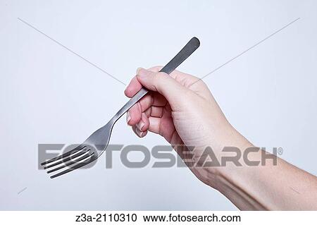 Hand Holding Fork, Hand Gesture, Studio shot View Large Photo Image Stock Image - Hand Holding Fork, Hand Gesture, Studio shot. Fotosearch