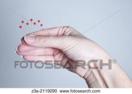Hand holding needles like a peacock. View Large Photo Image Stock Image - Hand holding needles like a peacock.. Fotosearch