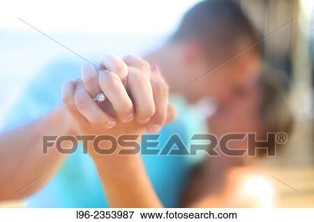 happy engaged couple kissing, showing off her engagement ring View Large Photo Image Stock Photo - happy engaged couple kissing, showing off her engagement ring. Fotosearch