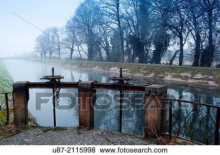 Italy, Lombardy, Crema, Canale Vacchelli, Canal in Winter. View Large Photo Image Stock Photo - Italy, Lombardy, Crema, Canale Vacchelli, Canal in Winter.. Fotosearch