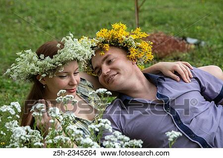 Lovers with wreaths on their heads retired in the park. View Large Photo Image Picture - Lovers with wreaths on their heads retired in the park.. Fotosearch