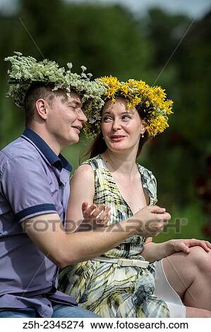 Picture - Lovers with wreaths on their heads retired in the park.. Fotosearch