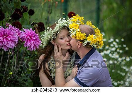 Stock Image - Lovers with wreaths on their heads retired in the park.. Fotosearch
