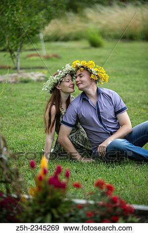 Stock Photo - Lovers with wreaths on their heads retired in the park.. Fotosearch