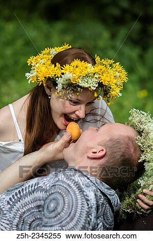 Stock Photography - Lovers with wreaths on their heads retired in the park.. Fotosearch