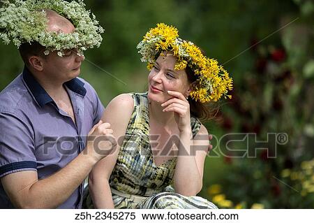 Stock Photography - Lovers with wreaths on their heads retired in the park.. Fotosearch