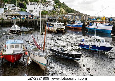 low tide in harbour, Polperro, view of the harbour in the touristic village on southern coast of Cornwall with low tide and boats aground. View Large Photo Image Stock Photo - low tide in harbour, Polperro, view of the harbour in the touristic village on southern coast of Cornwall with low tide and boats aground.. Fotosearch