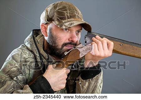 Man in camouflage with shotgun View Large Photo Image Stock Image - Man in camouflage with shotgun. Fotosearch