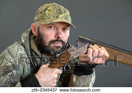 Man in camouflage with shotgun View Large Photo Image Stock Photo - Man in camouflage with shotgun. Fotosearch