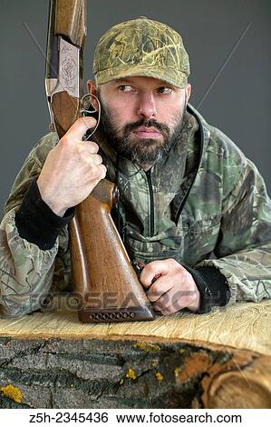 Man in camouflage with shotgun View Large Photo Image Stock Photograph - Man in camouflage with shotgun. Fotosearch
