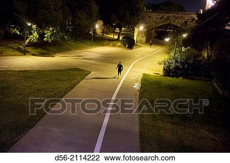 man running in old river bed Turia at night, Valencia, Spain. View Large Photo Image Stock Image - man running in old river bed Turia at night, Valencia, Spain.. Fotosearch