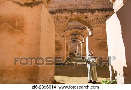 Meknes Morocco columns of Hri Souani former horse stalls in 17th century with arab man in robe in downtown with sunlight. View Large Photo Image Picture - Meknes Morocco columns of Hri Souani former horse stalls in 17th century with arab man in robe in downtown with sunlight.. Fotosearch