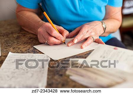 Middle aged woman writing Christmas cards. View Large Photo Image Stock Photo - Middle aged woman writing Christmas cards.. Fotosearch