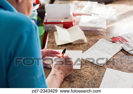 Middle aged woman writing Christmas cards. View Large Photo Image Stock Photo - Middle aged woman writing Christmas cards.. Fotosearch