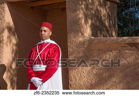Morocco Atlas Mountains Boulmane Danes village man in red traditional costume portrait at doorway. View Large Photo Image Stock Photography - Morocco Atlas Mountains Boulmane Danes village man in red traditional costume portrait at doorway.. Fotosearch