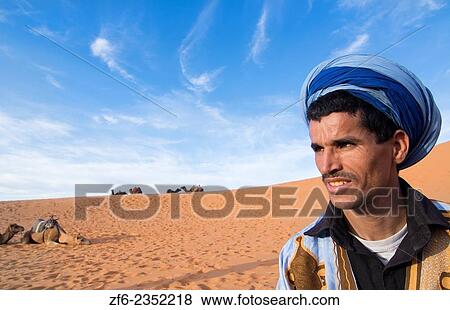 Morocco Sahara Desert sand dunes portrait of local man with turbin in Las Palmeras area. View Large Photo Image Stock Photo - Morocco Sahara Desert sand dunes portrait of local man with turbin in Las Palmeras area.. Fotosearch