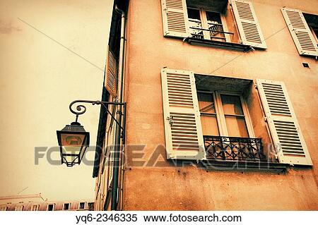 Stock Photography - Old, Parisian historic house with an old street lamp in vintage style. Fotosearch