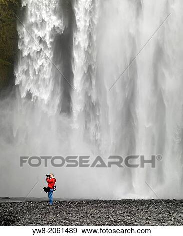 Stock Photo - Photographing at Skogafoss Waterfalls, Iceland.. Fotosearch