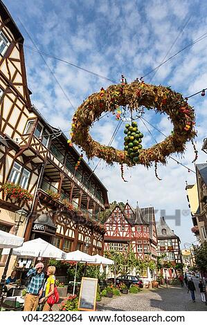 Picturesque timbered houses, 14th century Altes Haus (Old House) and harvest crown in Bacharach, Rhineland-Palatinate, Germany, Europe View Large Photo Image Picture - Picturesque timbered houses, 14th century Altes Haus (Old House) and harvest crown in Bacharach, Rhineland-Palatinate, Germany, Europe. Fotosearch