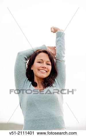 Portrait of a brunette woman breathing fresh air by the sea smiling at camera View Large Photo Image Stock Image - Portrait of a brunette woman breathing fresh air by the sea smiling at camera. Fotosearch