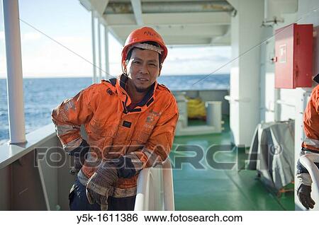 Stock Photograph - Portrait of an Indonesian seaman or sailor on the container-vessel MV Flintercape, during a journey from Rotterdam, Netherlands, to Sundsvall, Sweden. The man is an 'Able Seaman', who generally works on deck.. Fotosearch