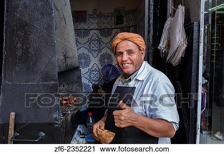 Rabat Morocco main medina local Arab man cooking meat in outdoor restaurant and smiling. View Large Photo Image Stock Image - Rabat Morocco main medina local Arab man cooking meat in outdoor restaurant and smiling.. Fotosearch