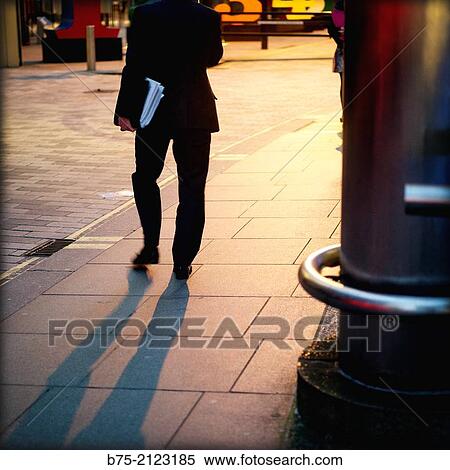 rear view of a unrecognizable man with portfolio walking on the street in London, England, UK, Europe View Large Photo Image Stock Photography - rear view of a unrecognizable man with portfolio walking on the street in London, England, UK, Europe. Fotosearch