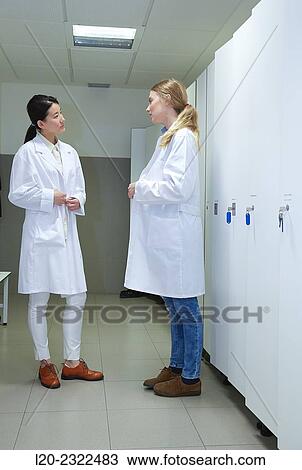 Stock Image - Researchers in the dressing room. White coats. Technological Services to Industry. Tecnalia Research and Innovation, Donostia, San Sebastian, Gipuzkoa, Basque Country, Spain.. Fotosearch