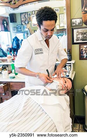 Rotterdam, Netherlands. Barber store Schorem. Male customer lying back in his barber chair while receiving a wet shave. View Large Photo Image Stock Image - Rotterdam, Netherlands. Barber store Schorem. Male customer lying back in his barber chair while receiving a wet shave.. Fotosearch