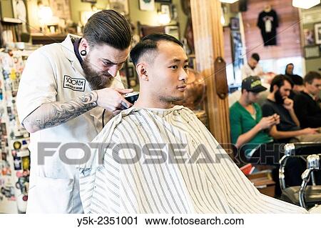 Rotterdam, Netherlands. Barber store Schorem. Barber helping his customer in his barber shop by cutting and modeling his hair. View Large Photo Image Stock Image - Rotterdam, Netherlands. Barber store Schorem. Barber helping his customer in his barber shop by cutting and modeling his hair.. Fotosearch