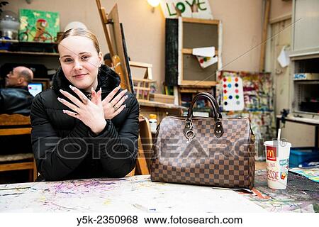 Stock Photo - Rotterdam, Netherlands. Beautiful young, blonde woman showing of her freshly done nails.. Fotosearch
