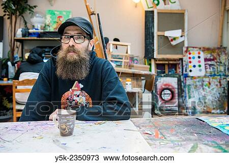 Rotterdam, Netherlands. Coordinator and chief artist of Via Kunst Studio's at his studio's production table View Large Photo Image Stock Image - Rotterdam, Netherlands. Coordinator and chief artist of Via Kunst Studio's at his studio's production table. Fotosearch
