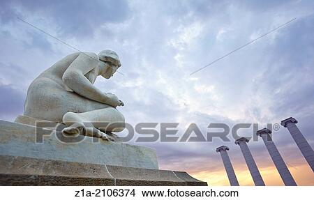 Picture - Sedent (seated), sculpture by Josep Llimona, and the Four Columns at Montjuic. Barcelona. Catalonia. Spain.. Fotosearch