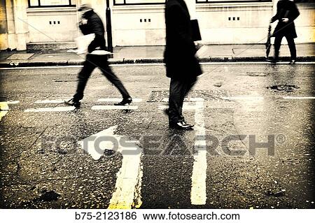 several executives across the street in different directions and a painted arrow on asphalt in London, England, UK, Europe View Large Photo Image Stock Photograph - several executives across the street in different directions and a painted arrow on asphalt in London, England, UK, Europe. Fotosearch