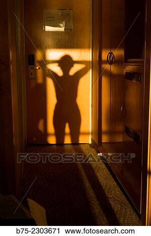 Stock Image - Shadow of the body of a woman in the hallway of a hotel room at the Dead Sea, Israel, Middle East. Fotosearch