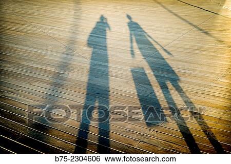 Shadow of the silhouette of a photographer taking a picture to a woman with a shopping bag, in Tel Aviv Harbour, Israel, Middle East View Large Photo Image Stock Photograph - Shadow of the silhouette of a photographer taking a picture to a woman with a shopping bag, in Tel Aviv Harbour, Israel, Middle East. Fotosearch