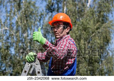Sling work on the construction of the house. View Large Photo Image Stock Photo - Sling work on the construction of the house.. Fotosearch