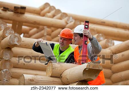Supervisor and discuss the work plan for a house under construction. View Large Photo Image Stock Photo - Supervisor and discuss the work plan for a house under construction.. Fotosearch