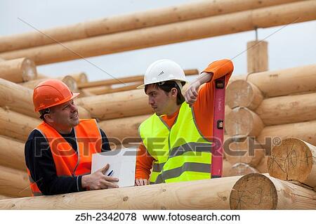 Stock Photo - Supervisor and discuss the work plan for a house under construction.. Fotosearch