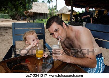 Stock Photo - Taking breakfast in Beach on the island of Koh Russei. Cambodia. Travel with children's. Father traveling with her daughter. Fotosearch