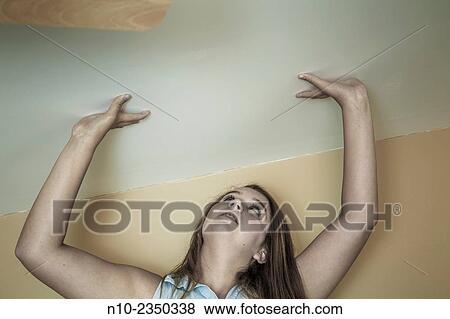 Teen girl touching her ceiling. View Large Photo Image Stock Photo - Teen girl touching her ceiling.. Fotosearch