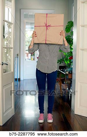 Teenage hidden behind a gift package View Large Photo Image Stock Photography - Teenage hidden behind a gift package. Fotosearch
